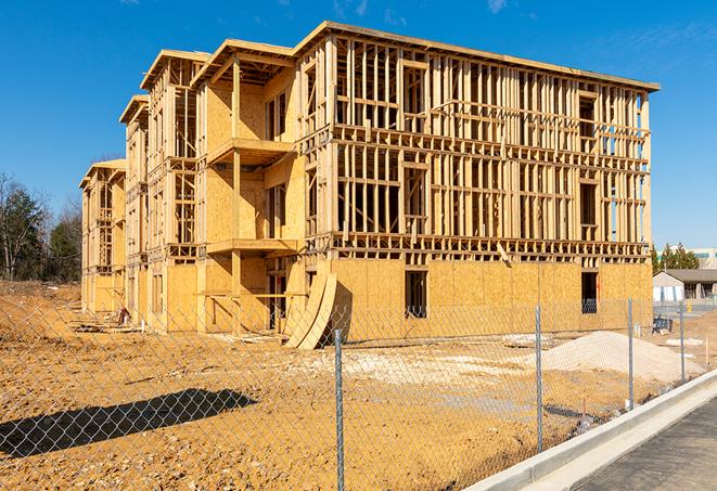 a close-up of temporary chain link fences enclosing a construction site, signaling progress in the project's development in Sullivans Island